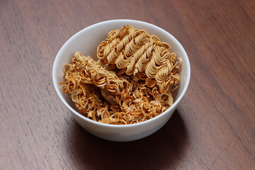 Raw noodles in white bowl