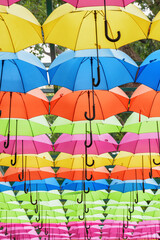 Fototapeta na wymiar Bottom view of colorful canopy of umbrellas in a park