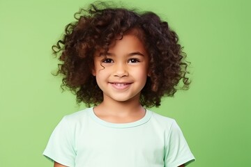 beautiful african american little girl with curly hair over green background