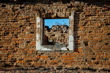 broken window in the wall of old house