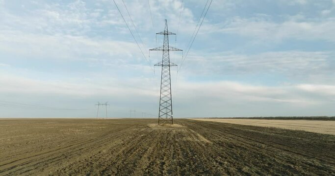 Power Lines and High Voltage Electricity Transmission Pylon.Power Lines Supply With Wire. Aerial drone view High Voltage Electric Tower With Insulators. Electricity Transportation Industry Energetics
