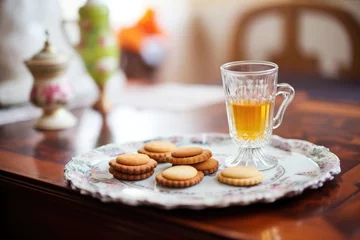 Fotobehang small glass of sherry with almond cookies on a tray © studioworkstock