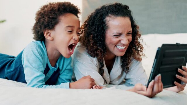Selfie, tablet and mother and son on a bed with crazy, expression or funny faces in their home. Love, family and African mom with kid in a bedroom for digital photography, profile picture or memory