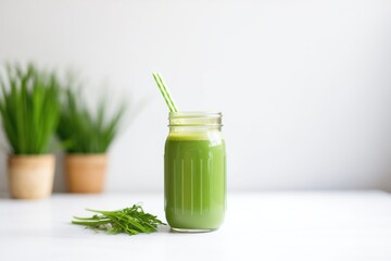 green juice in mason jar with straw and lime slice