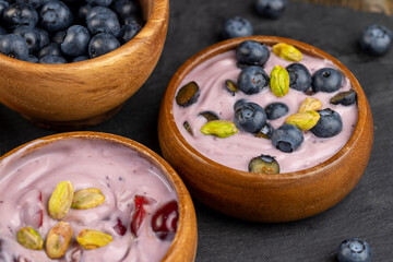fresh blueberry-flavored yogurt with ripe blueberries and pistachios