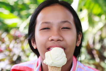 Young woman hold an ice cream cone in your hand and stick out your tongue to taste and have fun.