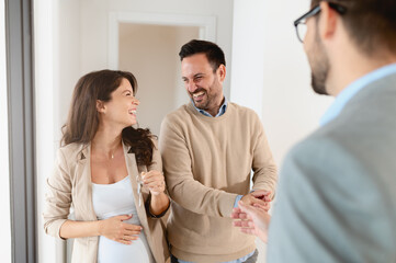 A young, beautiful, and excited married couple expecting a baby,  just decided to buy a property...