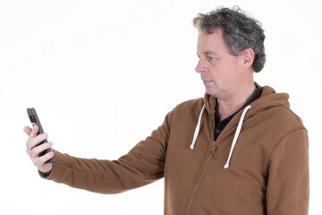 profile middle age man in looking smartphone screen reading message news on mobile phone cell against white background