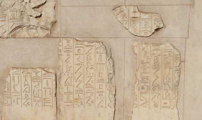 Ancient egyptian hieroglyphics carved on walls of Satet temple on Elephantine island in Aswan, Egypt
