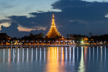 Nighttime View of Wat Phra Mahathat Kaen Nakhon, Wat Nong Waeng, in Khon Ka  Thailand, showcasing its ancient Thai architecture, golden pagoda, and cultural significance amidst the city lights - obrazy, fototapety, plakaty