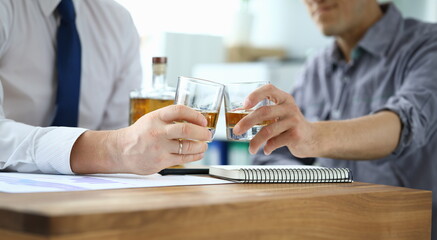 Men in suits drink alcohol in workplace at office. Communication business partners and solving...