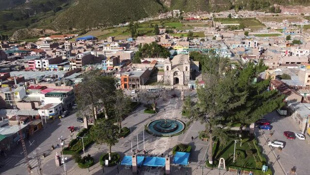Colca Canyon, Peru: Aerial footage of the Plaza de Armas in the Chivay town in the in the Colca Canyon in the Andes mountains in Peru in south America with a tilt up motion