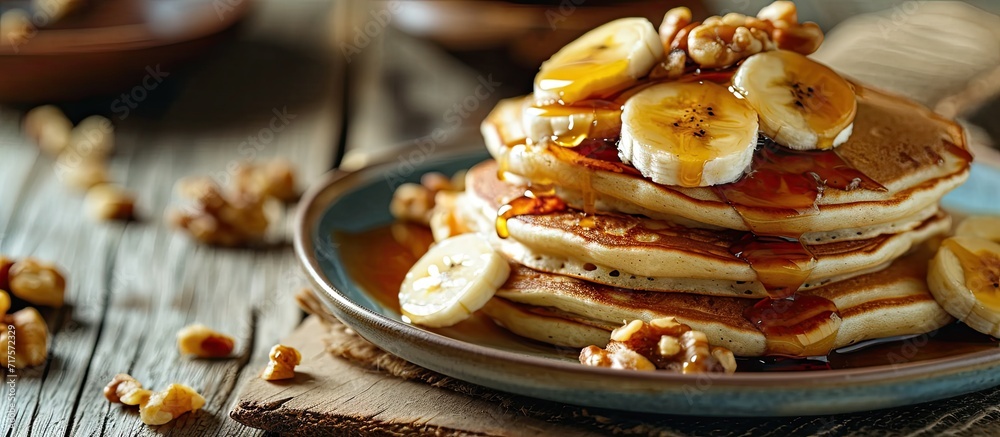 Poster Pancakes with banana walnut and caramel for a breakfast. Copy space image. Place for adding text or design
