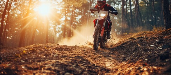 Motorcycle balance and motion blur with a man at a race on space in the forest for dirt biking Bike fitness and power with a sports person driving fast on an off road course for freedom or spee - obrazy, fototapety, plakaty