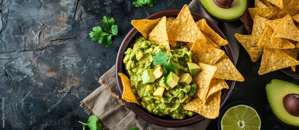 Aufkleber guacamole avocado mash dip with tortilla chips and fresh avocados. copy space image. place for addin