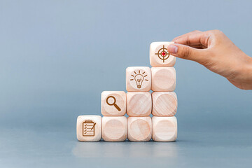 Place wooden blocks as a step towards the goal. Isolated on gray background. Business ideas for successful growth process. - obrazy, fototapety, plakaty