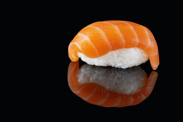 Composition of fresh salmon sashimi sushi isolated on a black background with reflect.A healthy delicacy.Copy space. Place for your text.