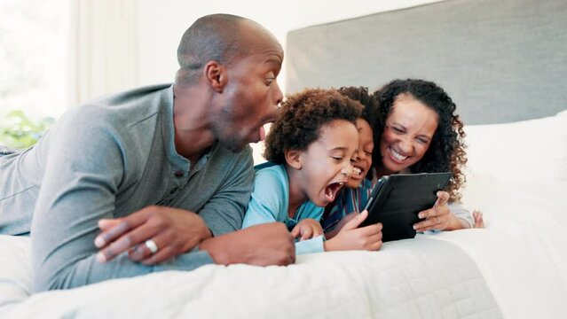 Tablet, happy and children with parents on bed watching funny, comic or comedy video on social media. Laugh, bond and boy kids relax and stream movie on digital technology with mom and dad in bedroom
