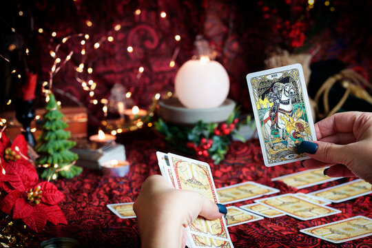  Tarot reader or Fortune teller reading on Christmas decoration.
