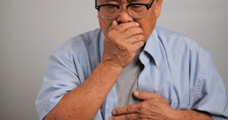 Elderly Asian man suffering from respiratory disease.