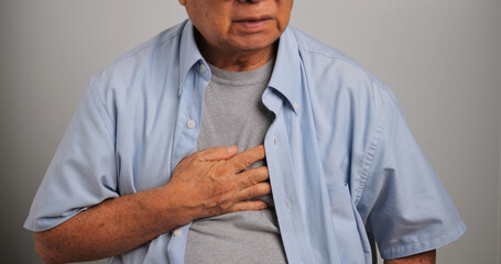Asian old man has difficulty breathing. An elderly man has dyspnea.