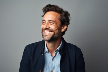 Fototapeta premium Handsome bearded man smiling on gray background, happy man