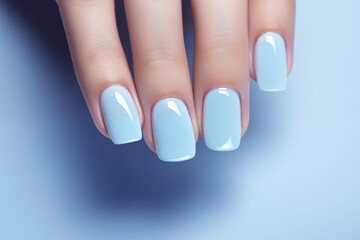 Glamour woman hand with blue nail polish on her fingernails. Pastel color nail manicure with gel...