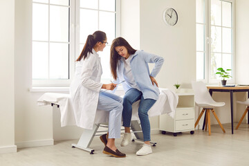 Sick young woman feeling unwell suffering from backache during meeting with her female therapist...