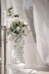 Details of the wedding decor, the arch for the newlyweds made of wood decorated with fresh flowers rose and eucalyptus