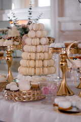 Pyramid of caramel and chocolate macarons at a wedding candy bar