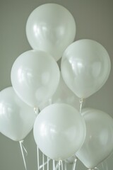 White balloons arranged on a table, suitable for parties and celebrations