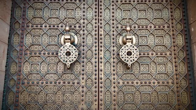 zoom out shot of a golden door at Hassan mosque. Rabat, Morocco