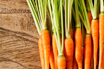 Fresh carrots on wooden table.