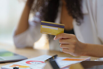 Close-up hand of a businesswoman holding a credit card.