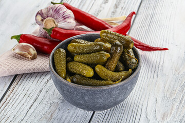 Marinated small cucumbers in the bowl