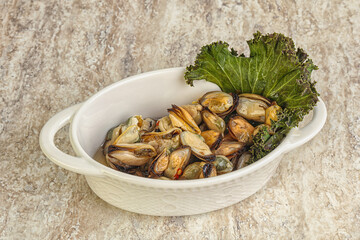 Tasty marinated mussels in the bowl