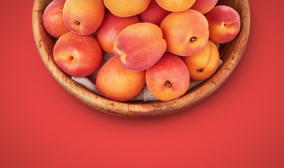 Fresh apricots in the wooden bowl still life of ripe fruits. Apricot Vegan organic healthy food still-life. Top View.