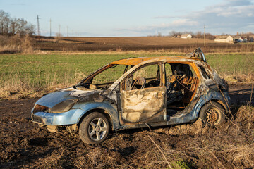 burned car wreck near to highway - 717639529