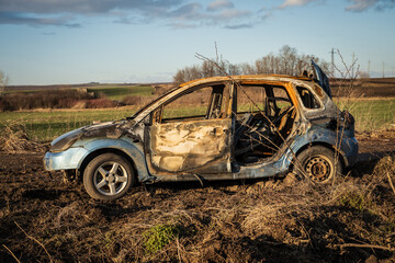 burned car wreck near to highway - 717639556