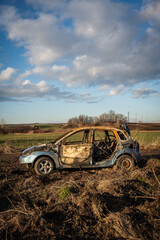 burned car wreck near to highway - 717639557