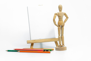 Wooden doll with empty easel on white background; business or creative concept