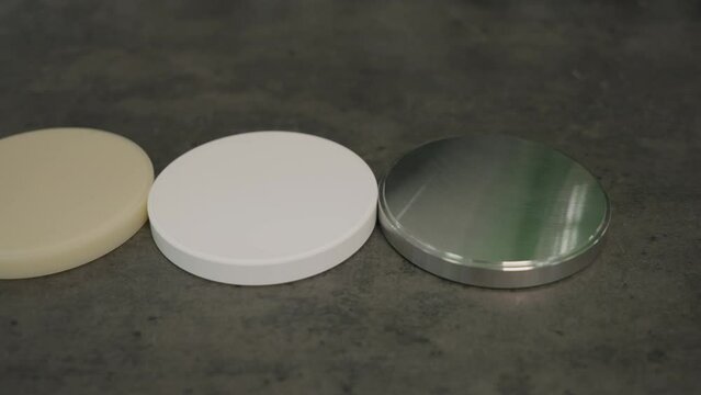 Close-up of the three dental zirconia blocks at the medical laboratory. Showcasing the dental zirconia blocks used for artificial crown manufacturing. Dental zirconia blocks for teeth restoration.