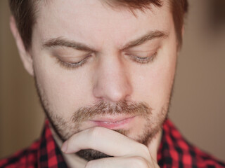 Portrait of pensive man with short hair.