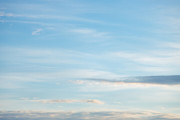 A beautiful sky tinted by the sun leaving vibrant shades of gold, pink, blue and multicolored. Clouds in the twilight evening and morning sky. Cloudy sky background in the evening and during the day.