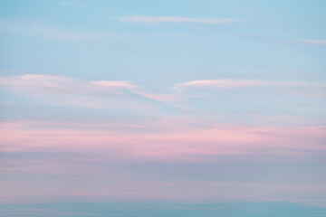 Obraz premium A beautiful sky tinted by the sun leaving vibrant shades of gold, pink, blue and multicolored. Clouds in the twilight evening and morning sky. Cloudy sky background in the evening and during the day.