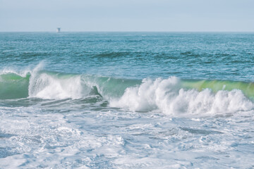 Wave splashing close-up. Crystal clear sea water, in the ocean in San Francisco Bay, blue water, pastel colors.
