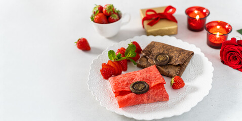 Valentine's day banner on white background. Envelope shaped pancakes with chocolate and fresh strawberries. Creative romantic breakfast. Web line for restaurant, cafe. Copy space. Side view
