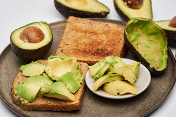 Fresh avocado on toast on white background