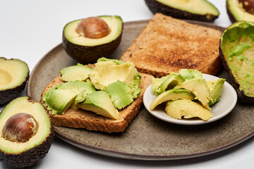 Fresh avocado on toast on white background