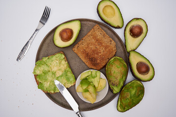 Fresh avocado on toast on white background